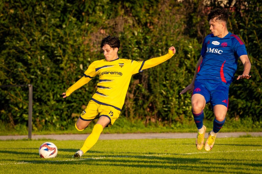 Intense soccer match with two players in action on the field.